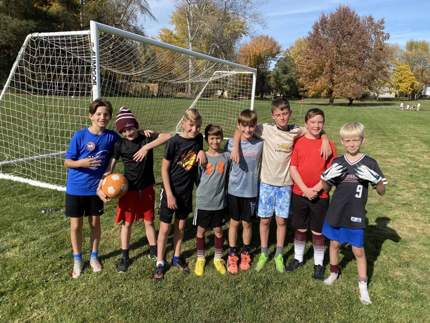 Kids posing in front of one of the new soccer goals